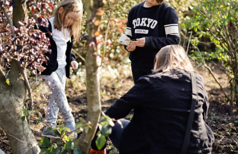 Lisa Crosher showing children how to plant the seeds